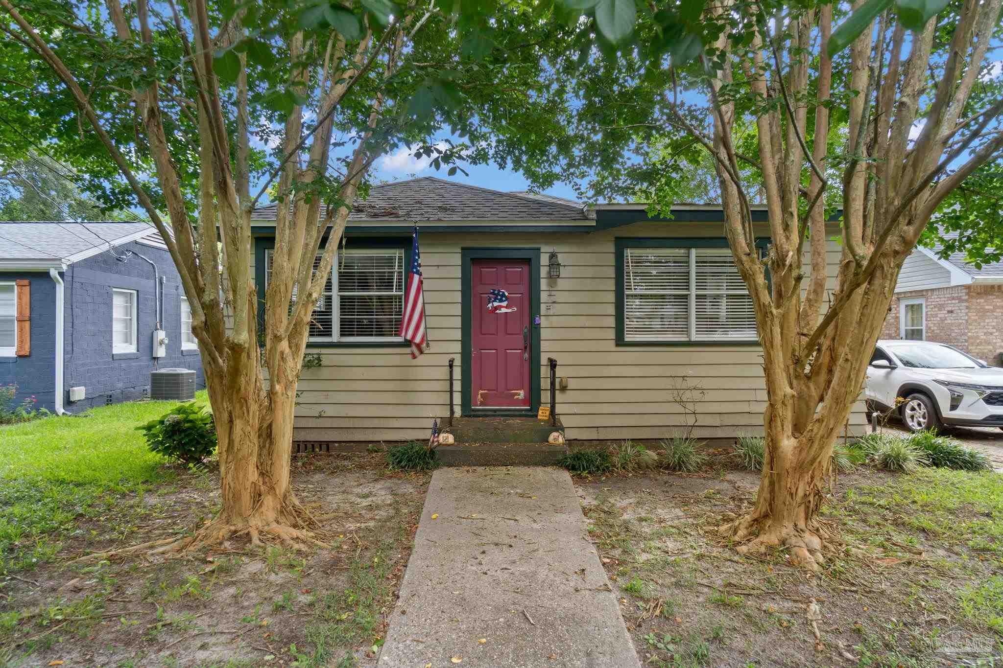 a front view of a house with garden