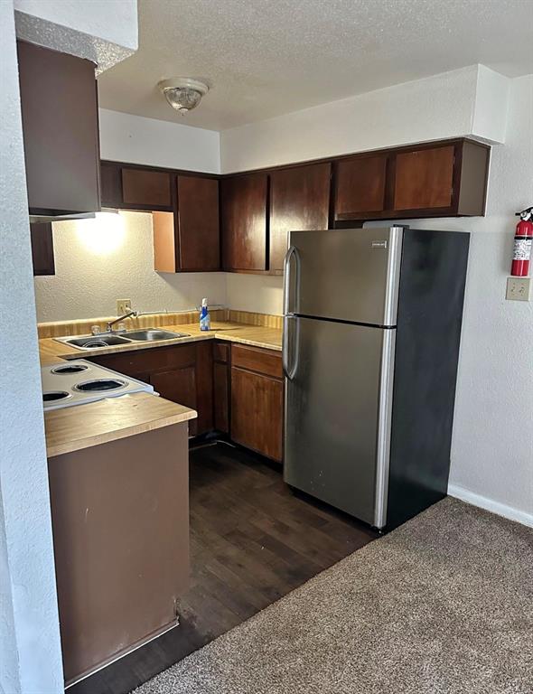 a kitchen with stainless steel appliances a refrigerator and a stove