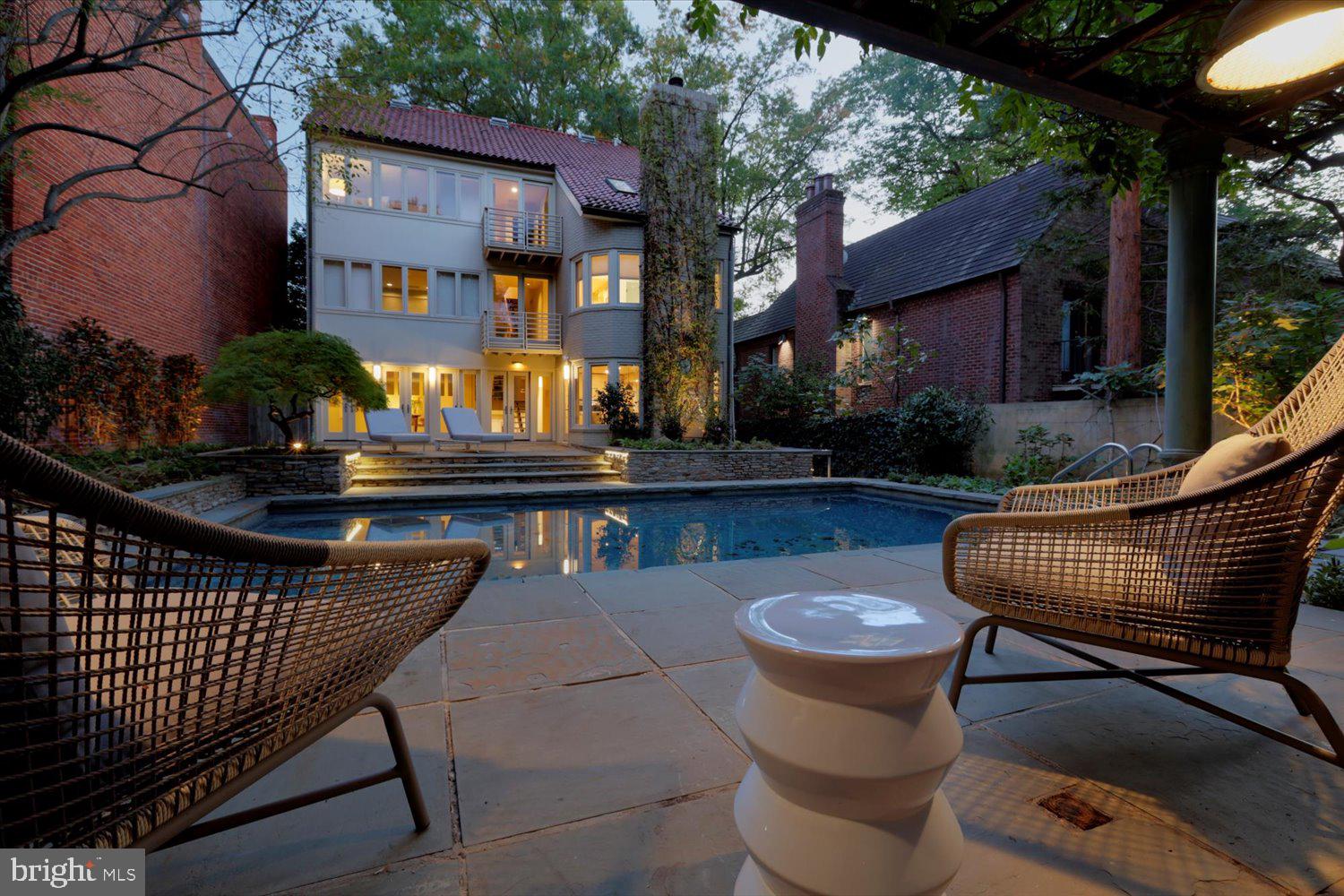 a view of a patio with couches table and chairs and potted plants