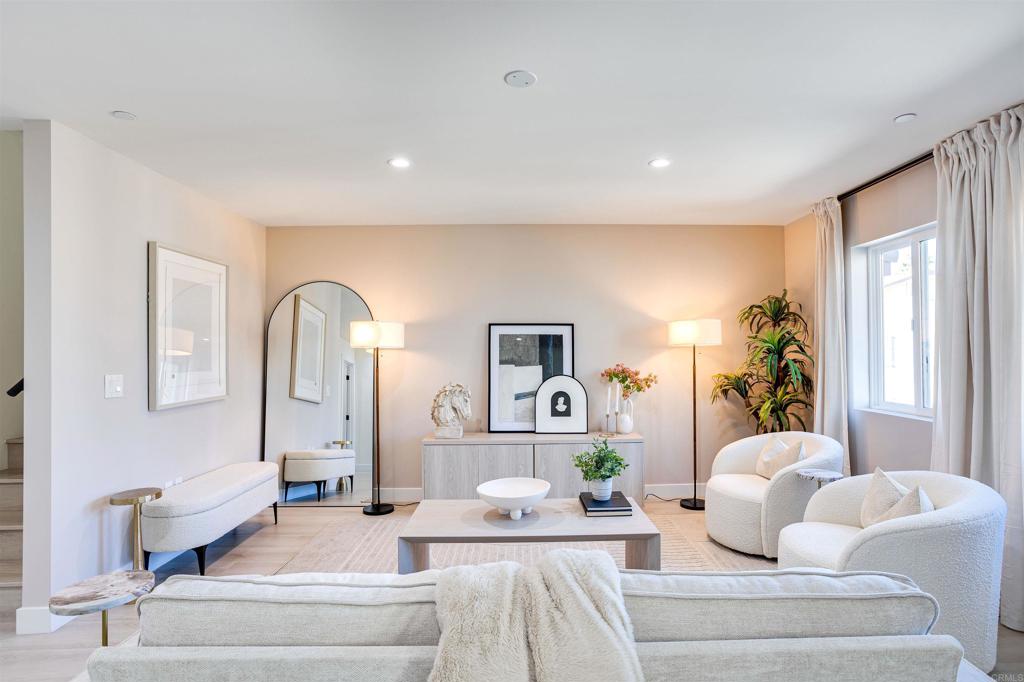 a living room with furniture and a large mirror