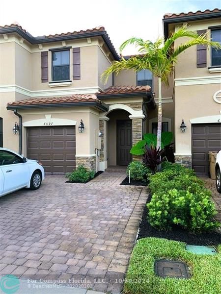 a view of a car parked front of a house