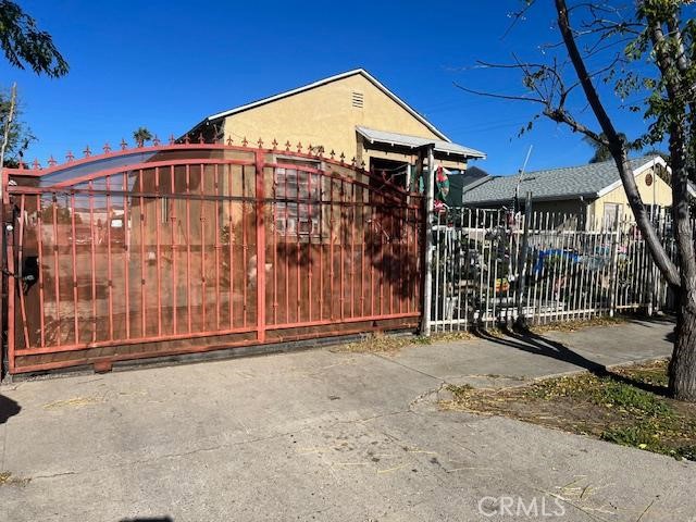 a view of a house with a wooden fence