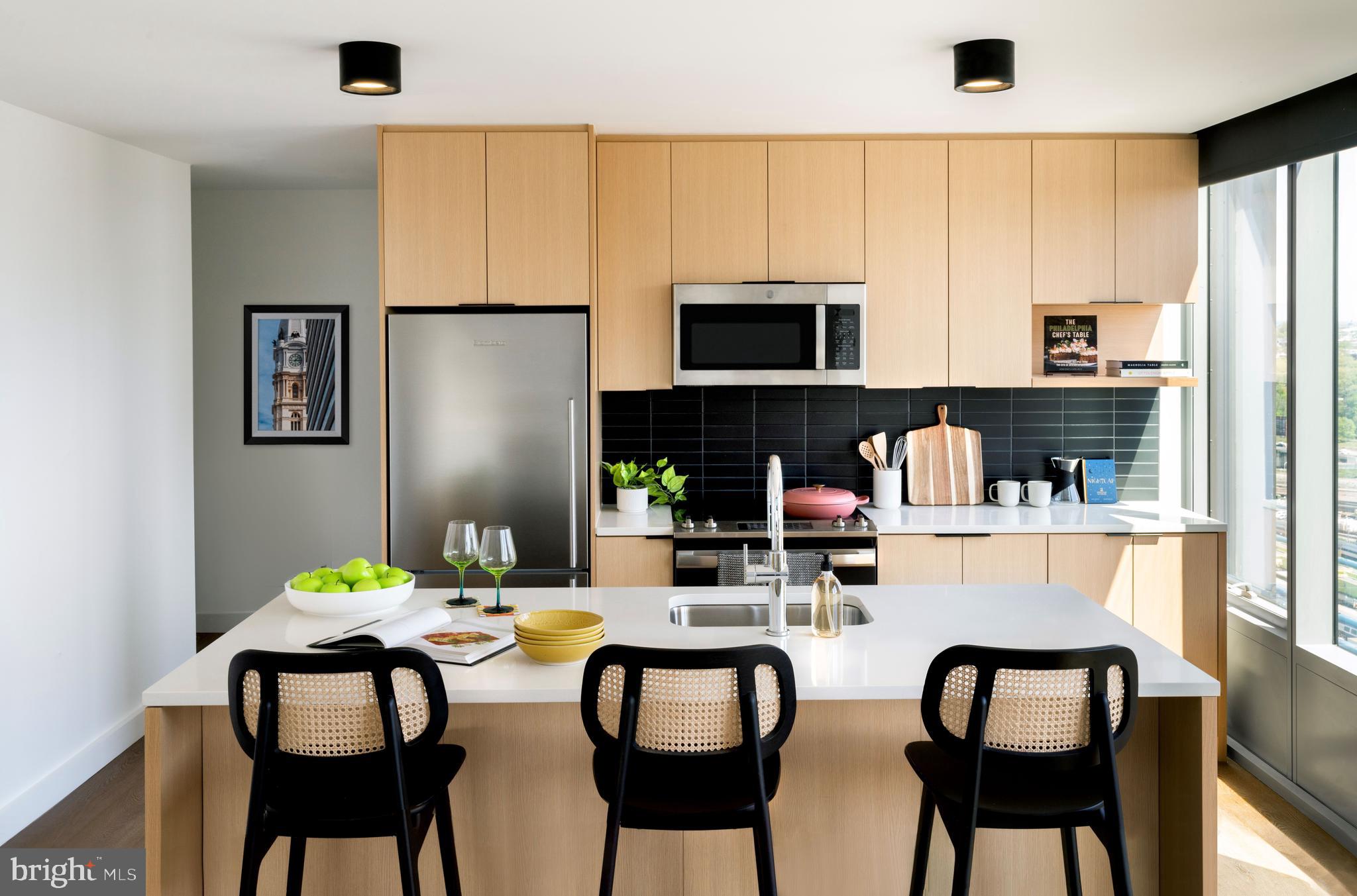 a kitchen with a table chairs and a refrigerator