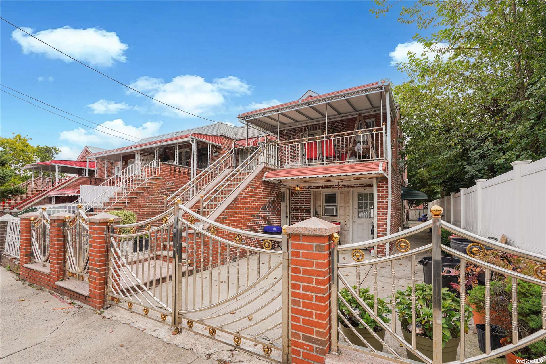 a view of a house with iron fence