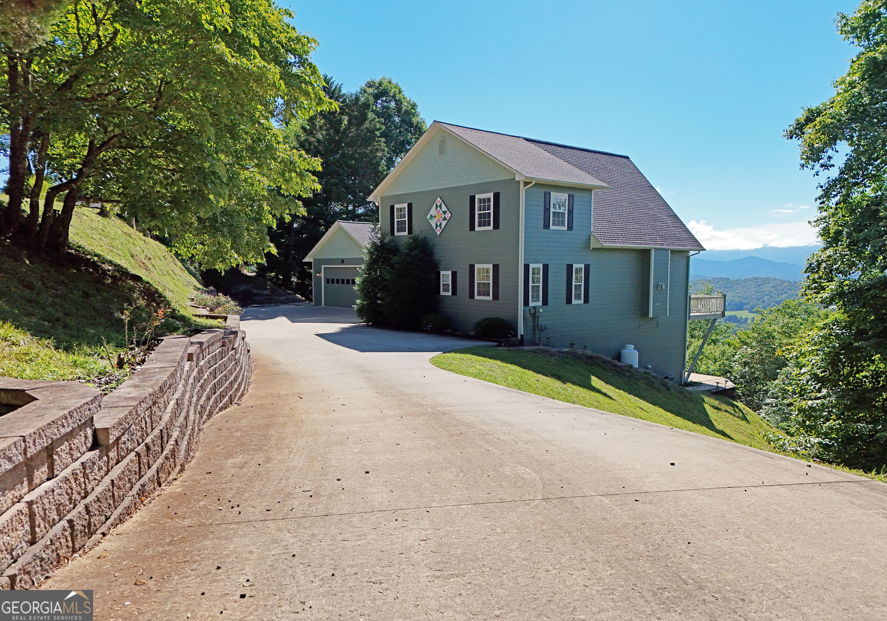 a view of a house with a yard and pathway