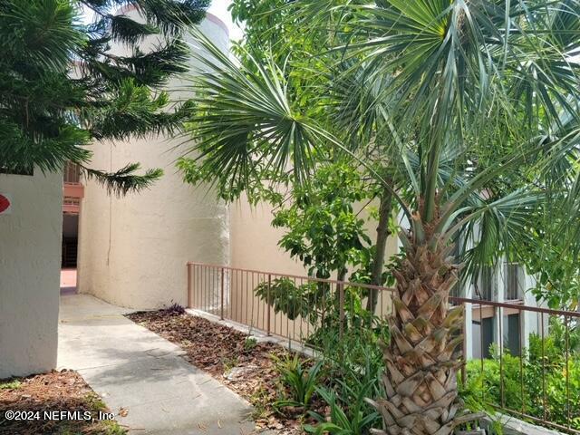 a backyard of a house with lots of potted plants