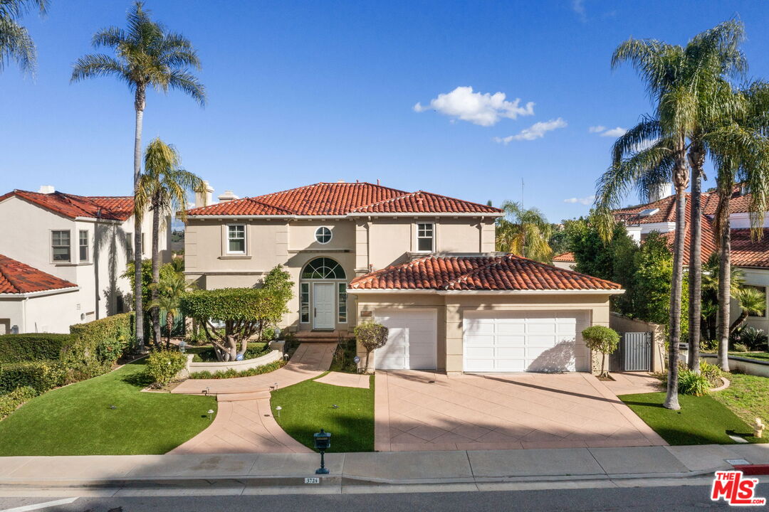 a front view of a house with yard and patio