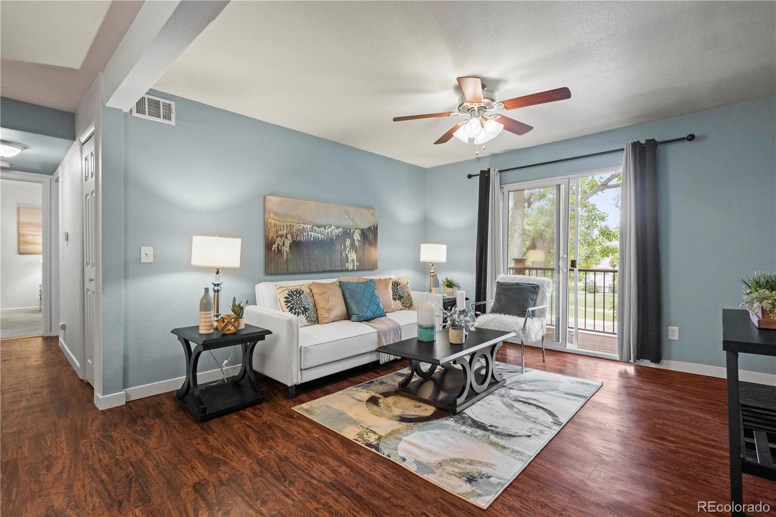 a living room with furniture and wooden floor