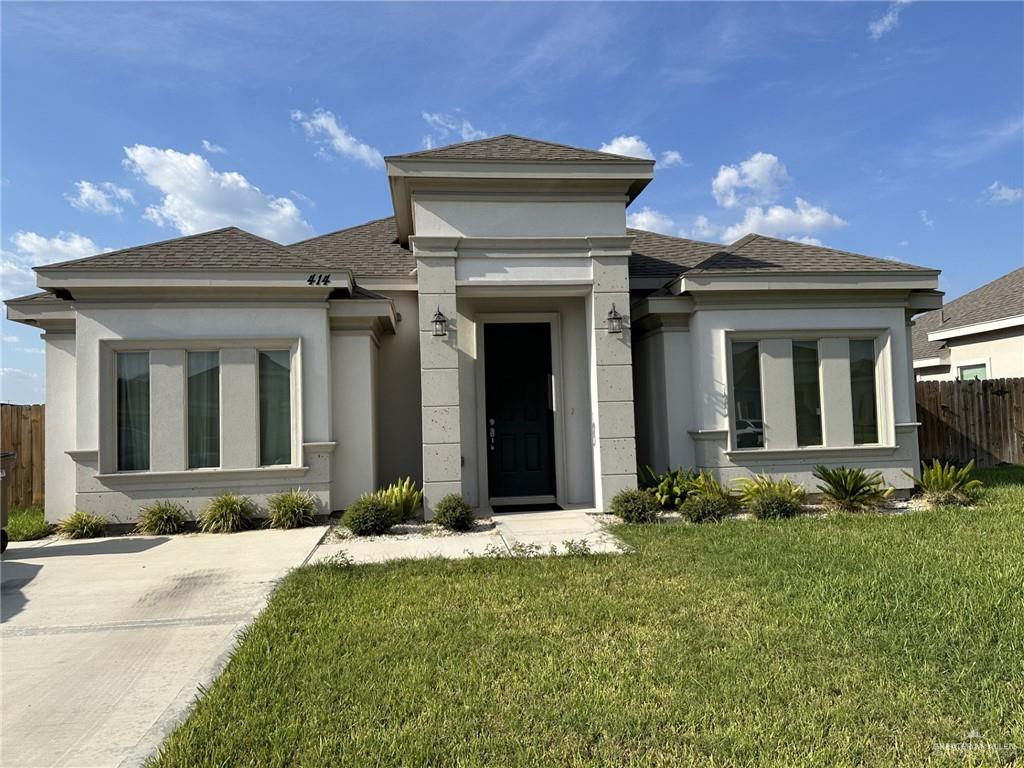 a front view of a house with yard