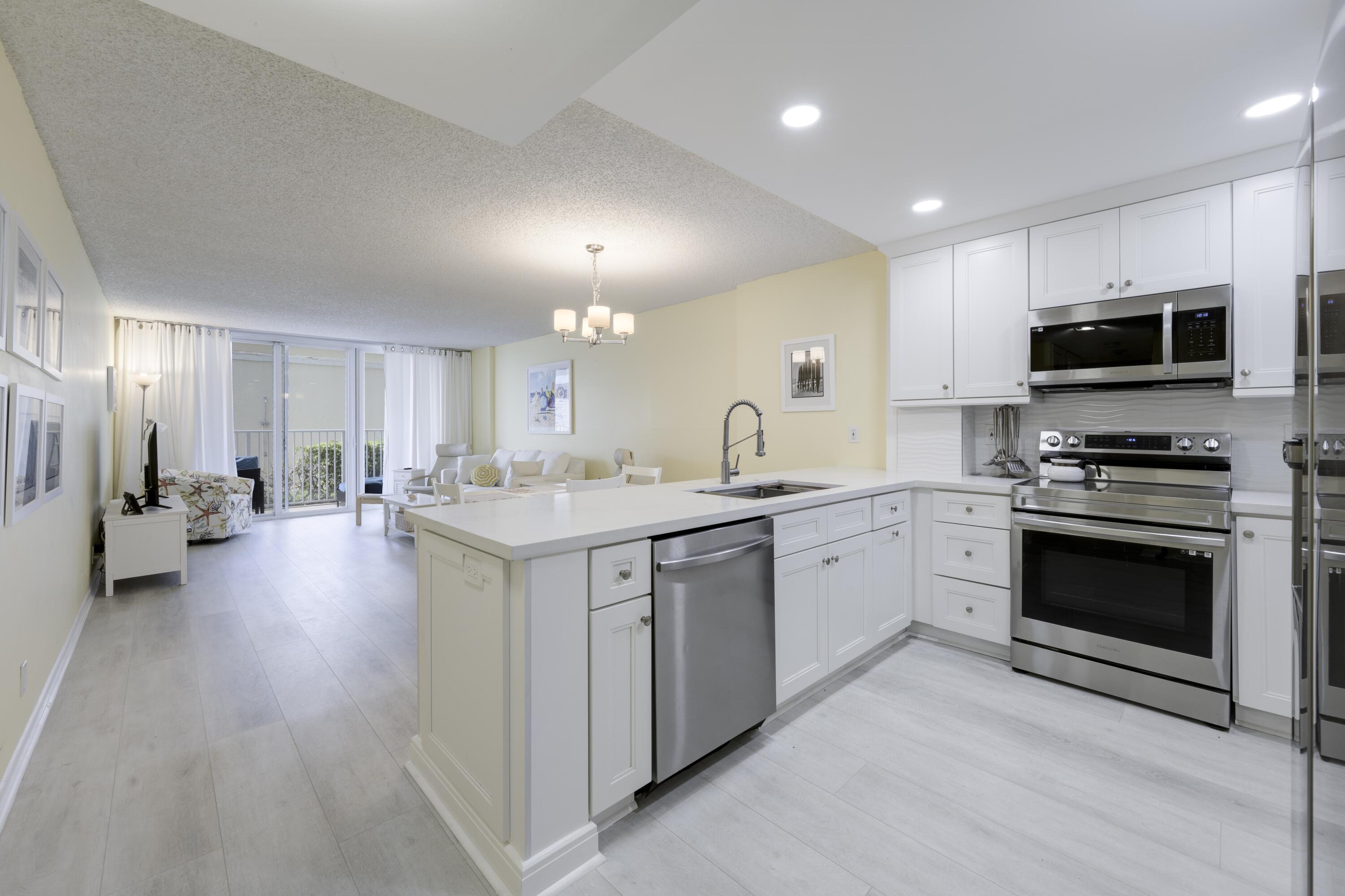 a kitchen with a sink stainless steel appliances and cabinets