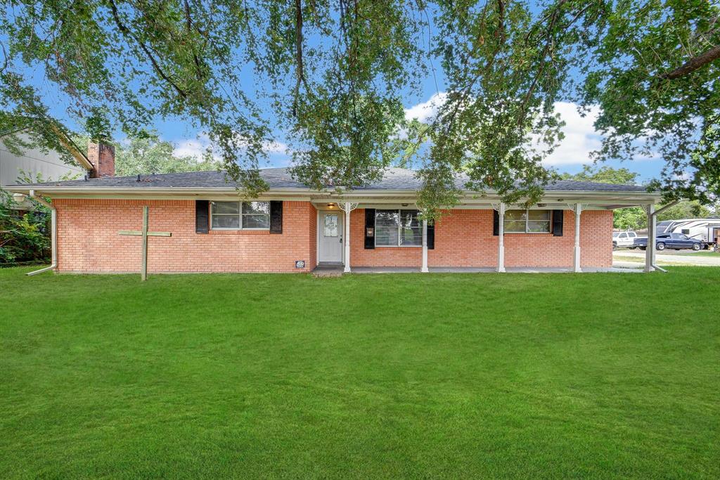 a front view of house with yard and green space