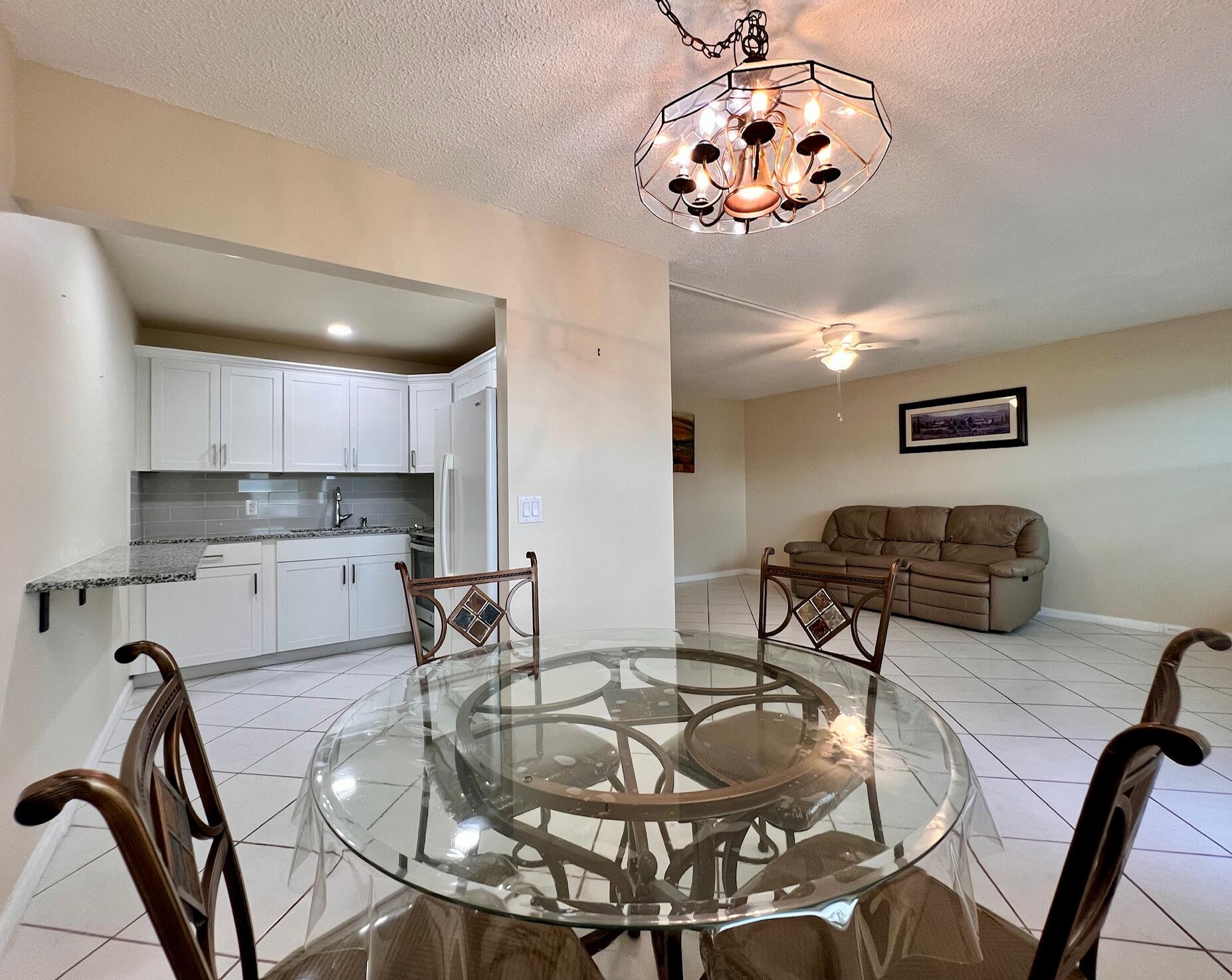 a room with table chairs and chandelier