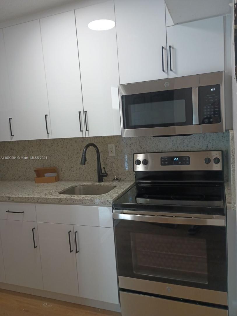 a kitchen with a stove and a microwave