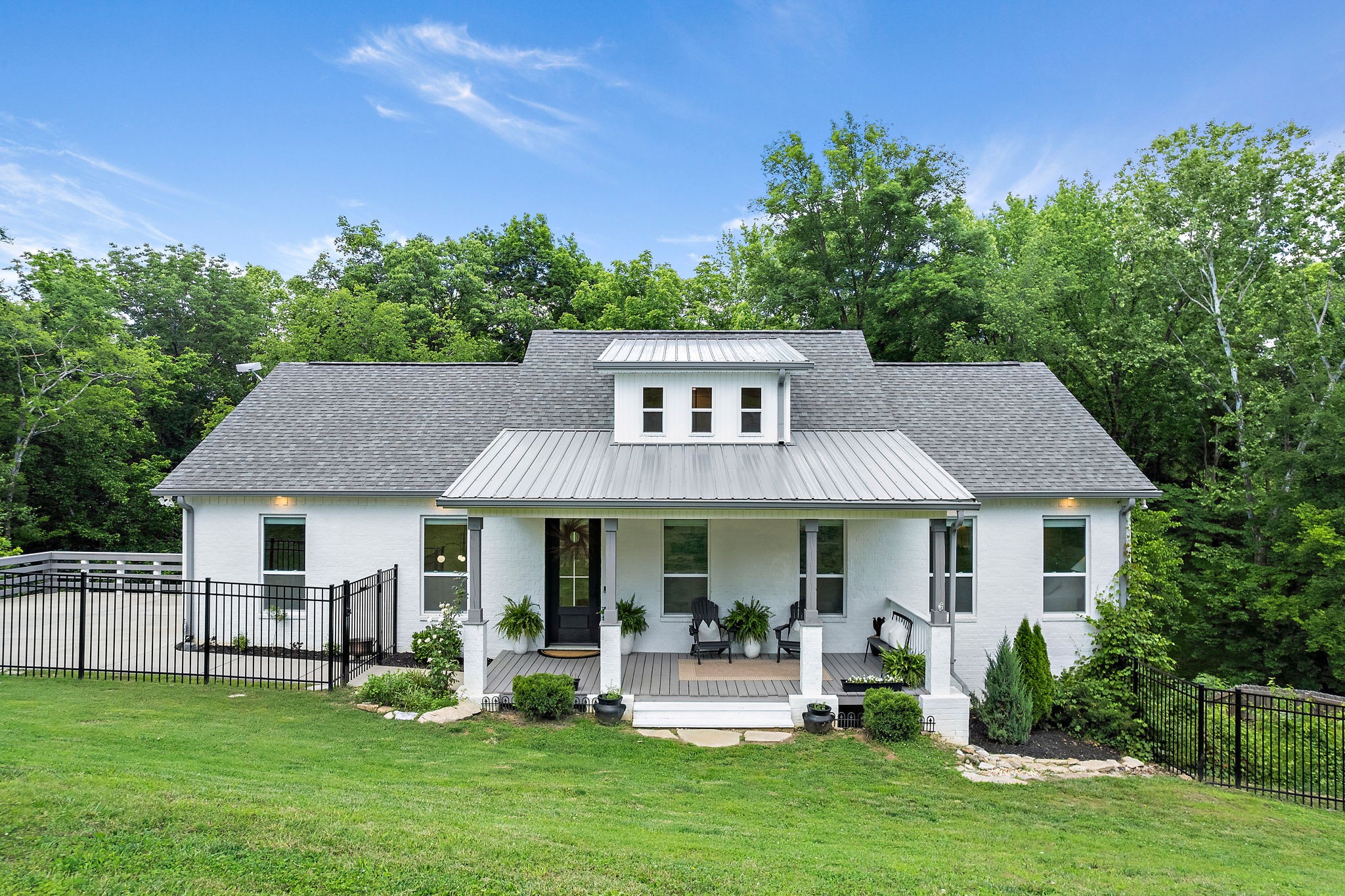 a front view of a house with a garden and porch