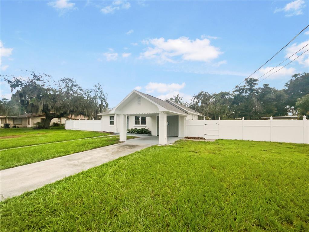 a front view of a house with yard and green space