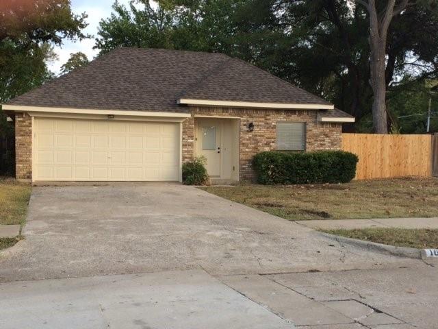 a view of a white house with a outdoor space and a garage