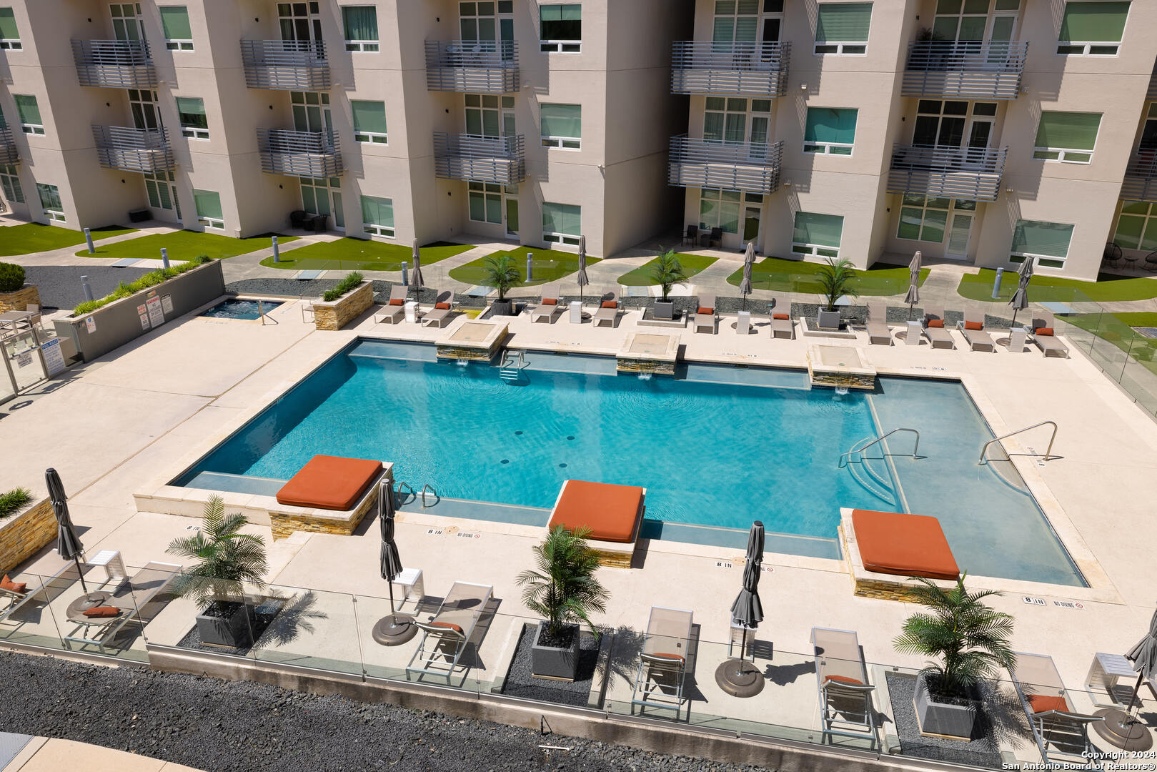 a swimming pool with outdoor seating and city view