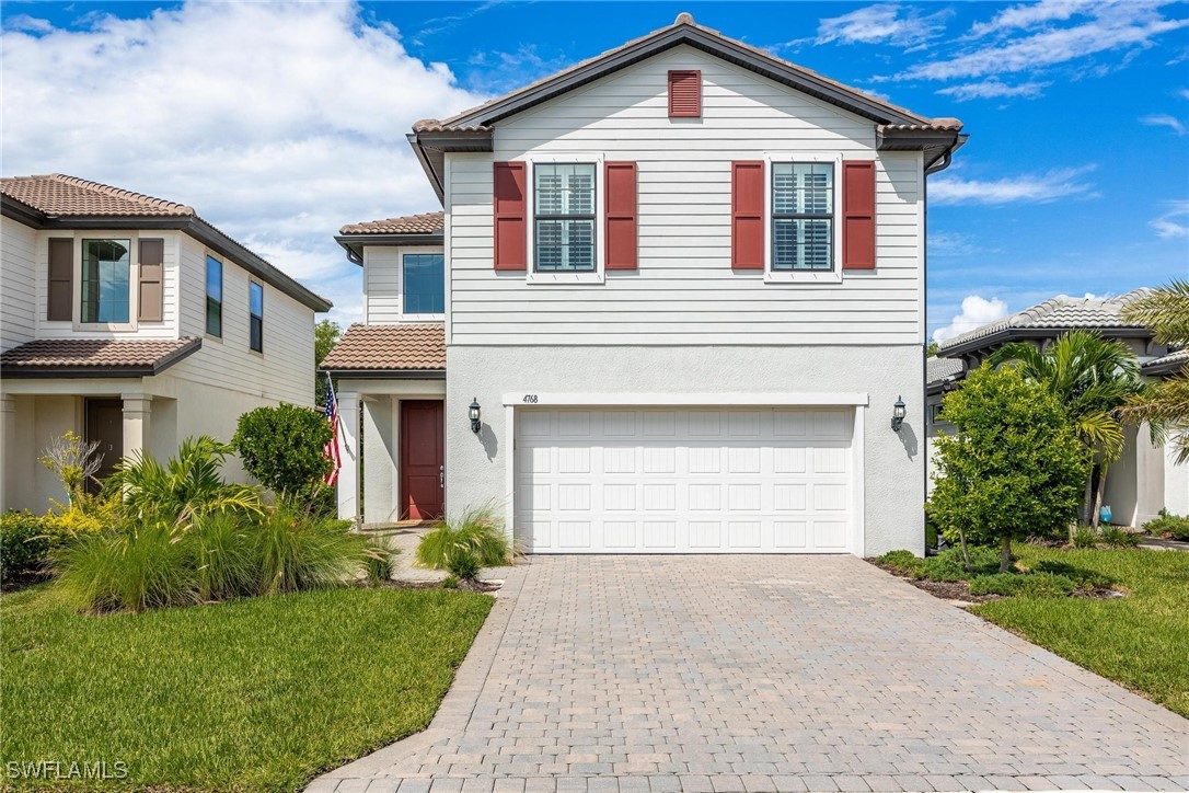 a front view of a house with a yard and garage