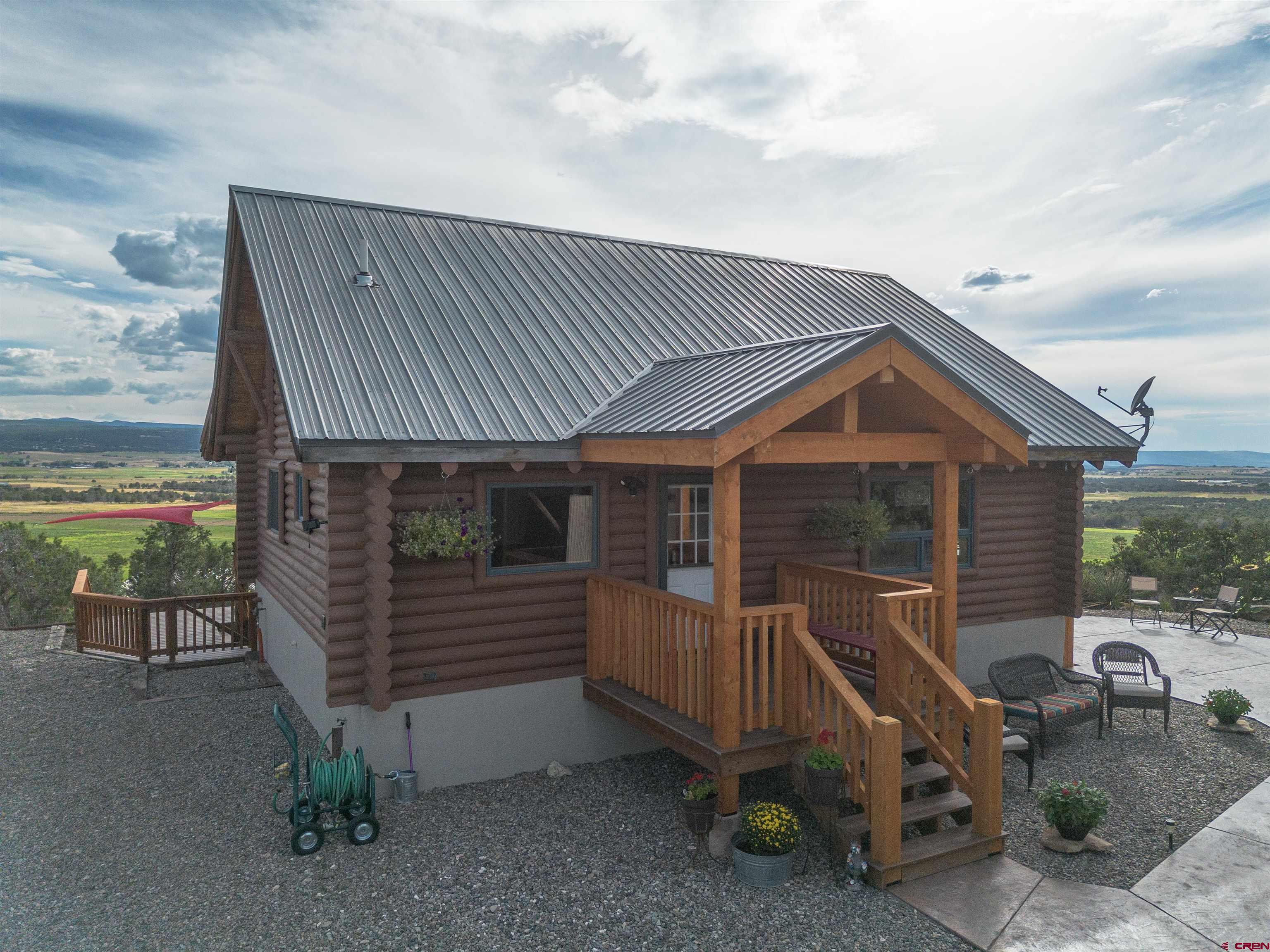 a view of backyard with deck and outdoor seating