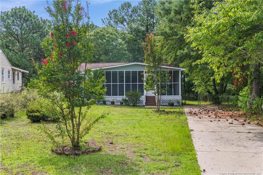 a view of a house with backyard and sitting area