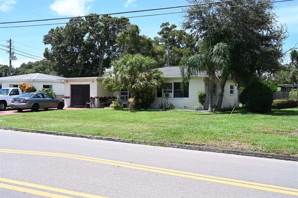 a front view of a house with a garden and yard