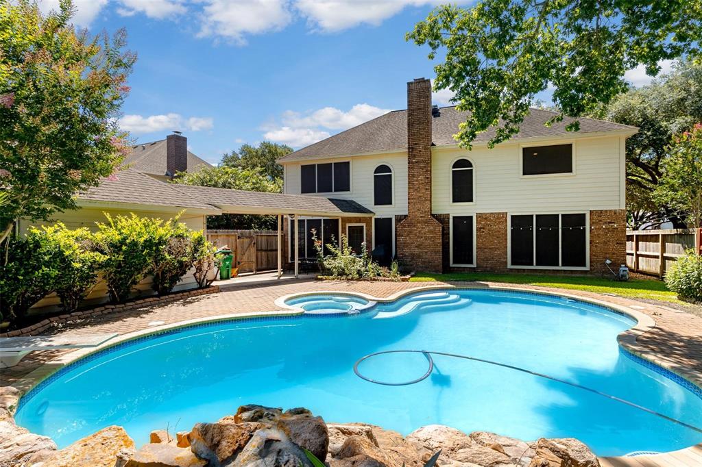 a view of a house with swimming pool and sitting area