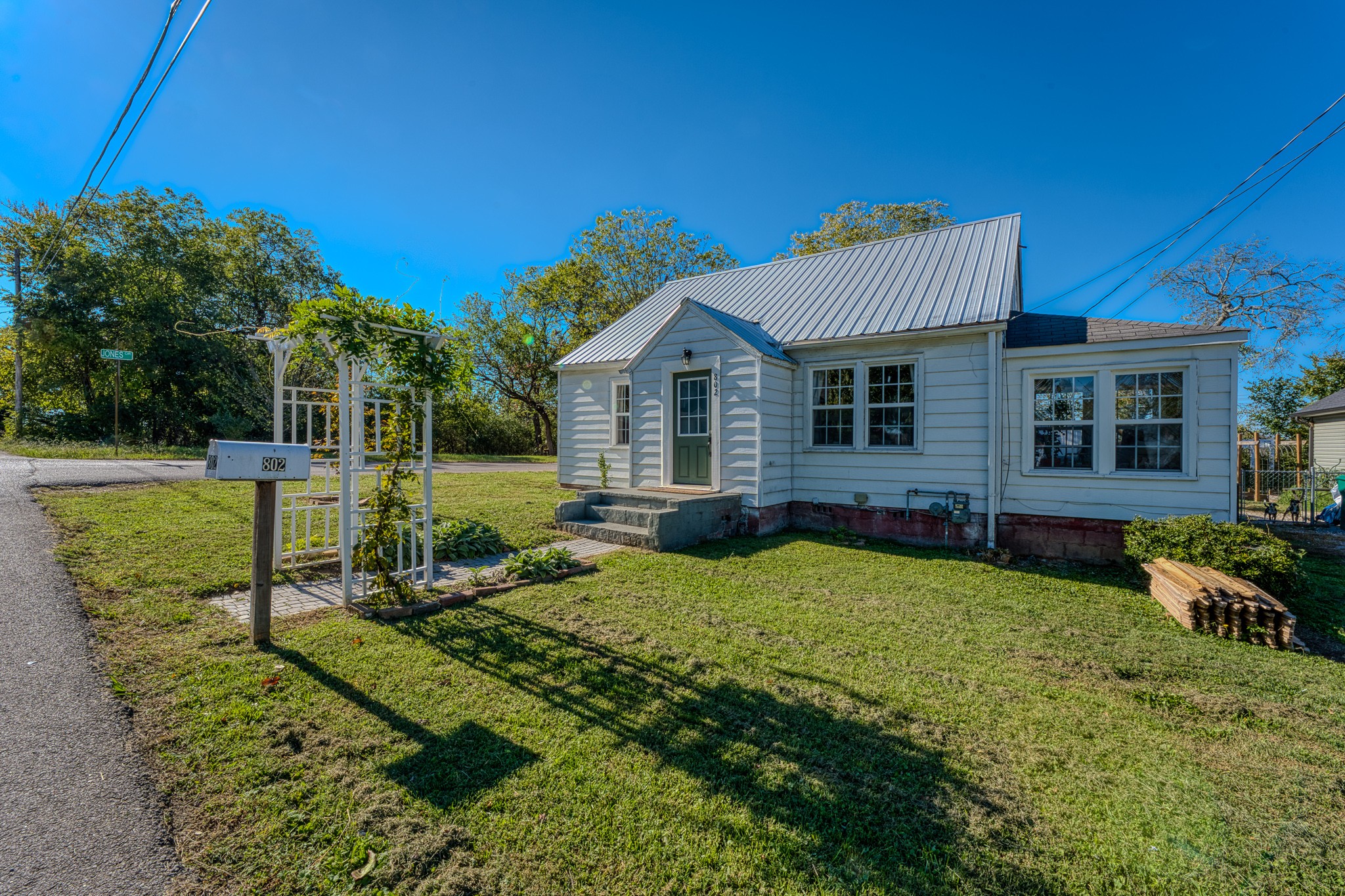 a view of a house with backyard sitting area and garden