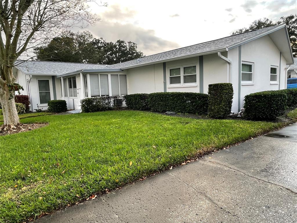 a front view of house with yard and green space