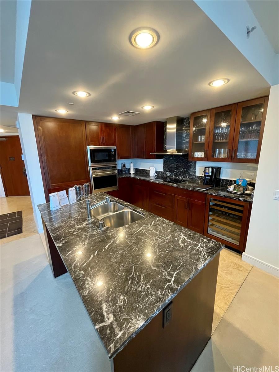 a kitchen with stainless steel appliances granite countertop a sink and a stove