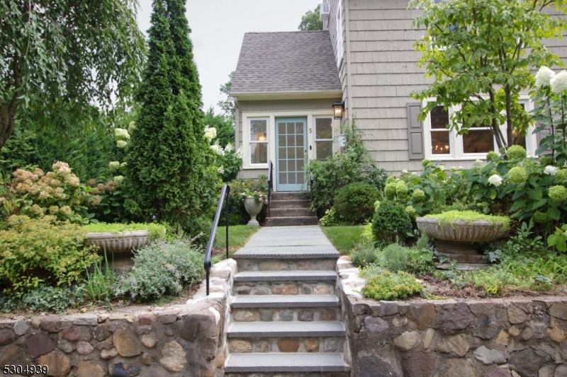 a view of a house with potted plants