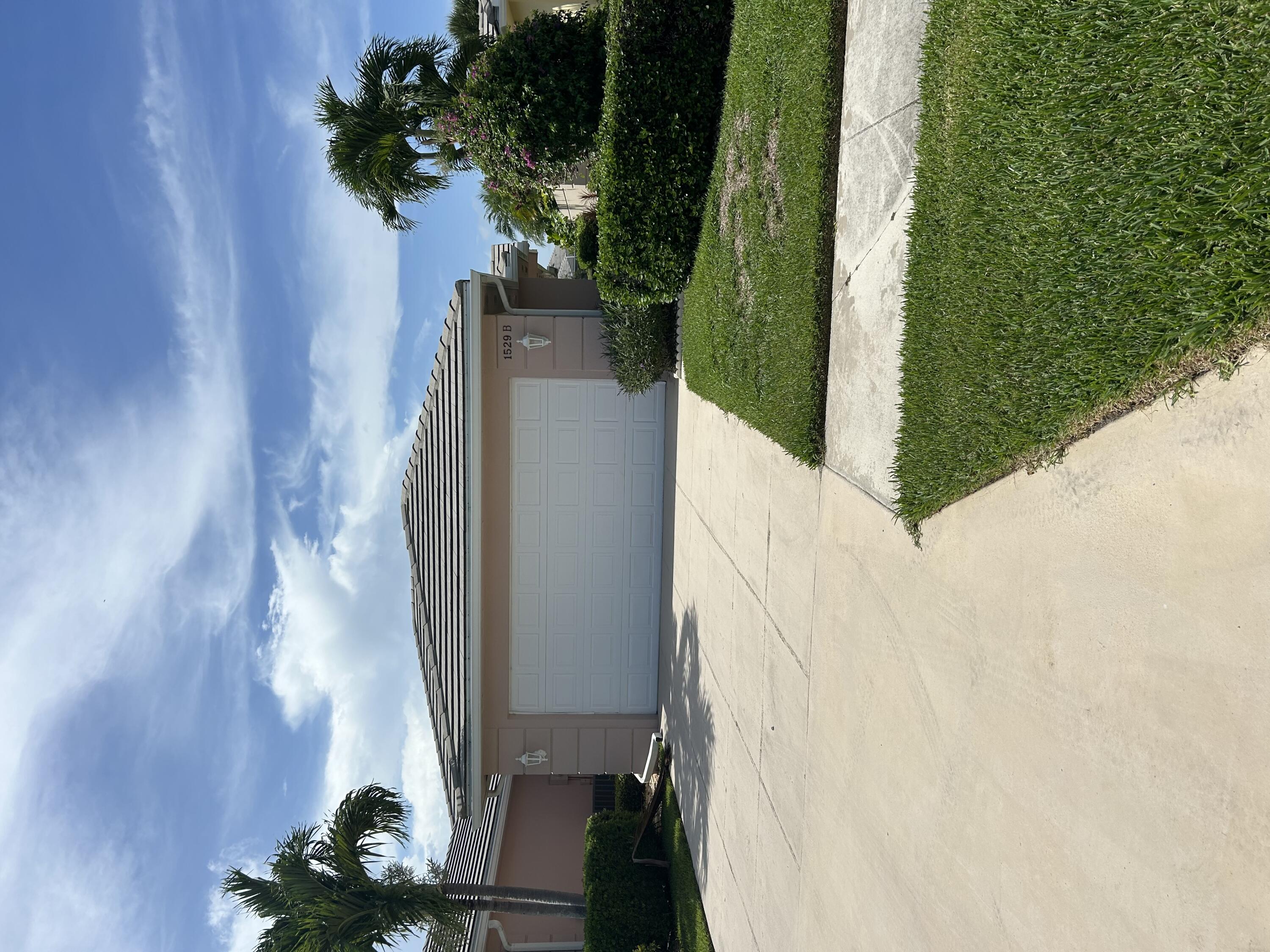 a view of a house with a yard and a garage