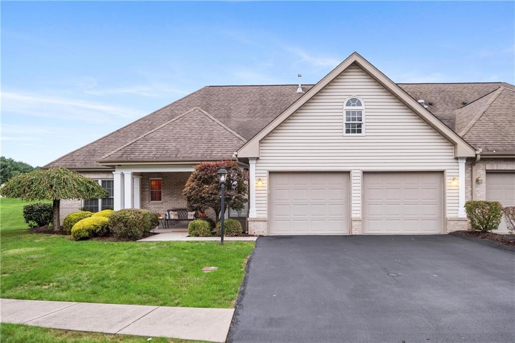 a view of a house with a yard and garage