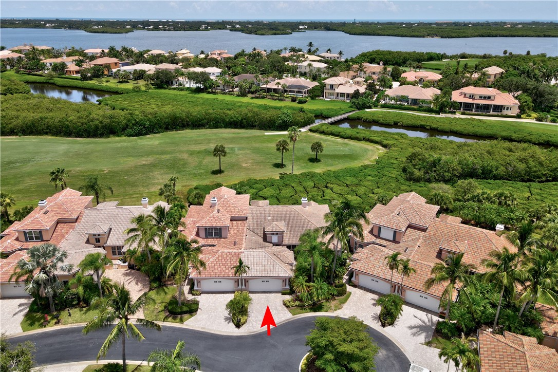 an aerial view of a house with a garden and lake view