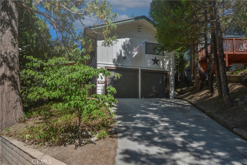 a view of a house with a yard and tree s