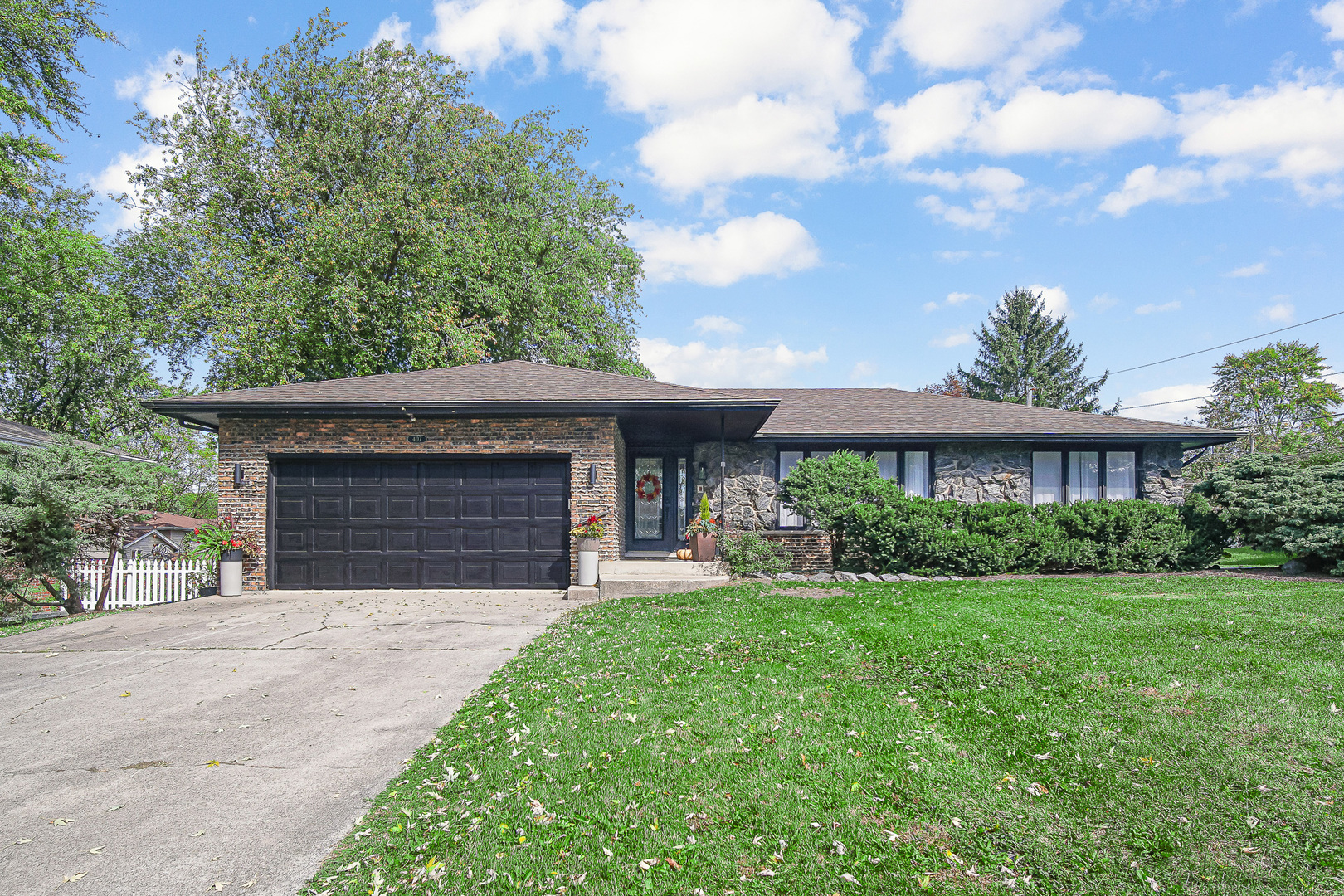 a front view of a house with a yard and garage