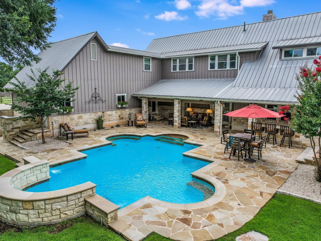 entertainment area with sitting area and outdoor kitchen that includes grill, refrigerator and kegerator.