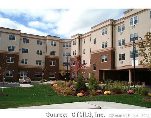 a front view of a building with a yard