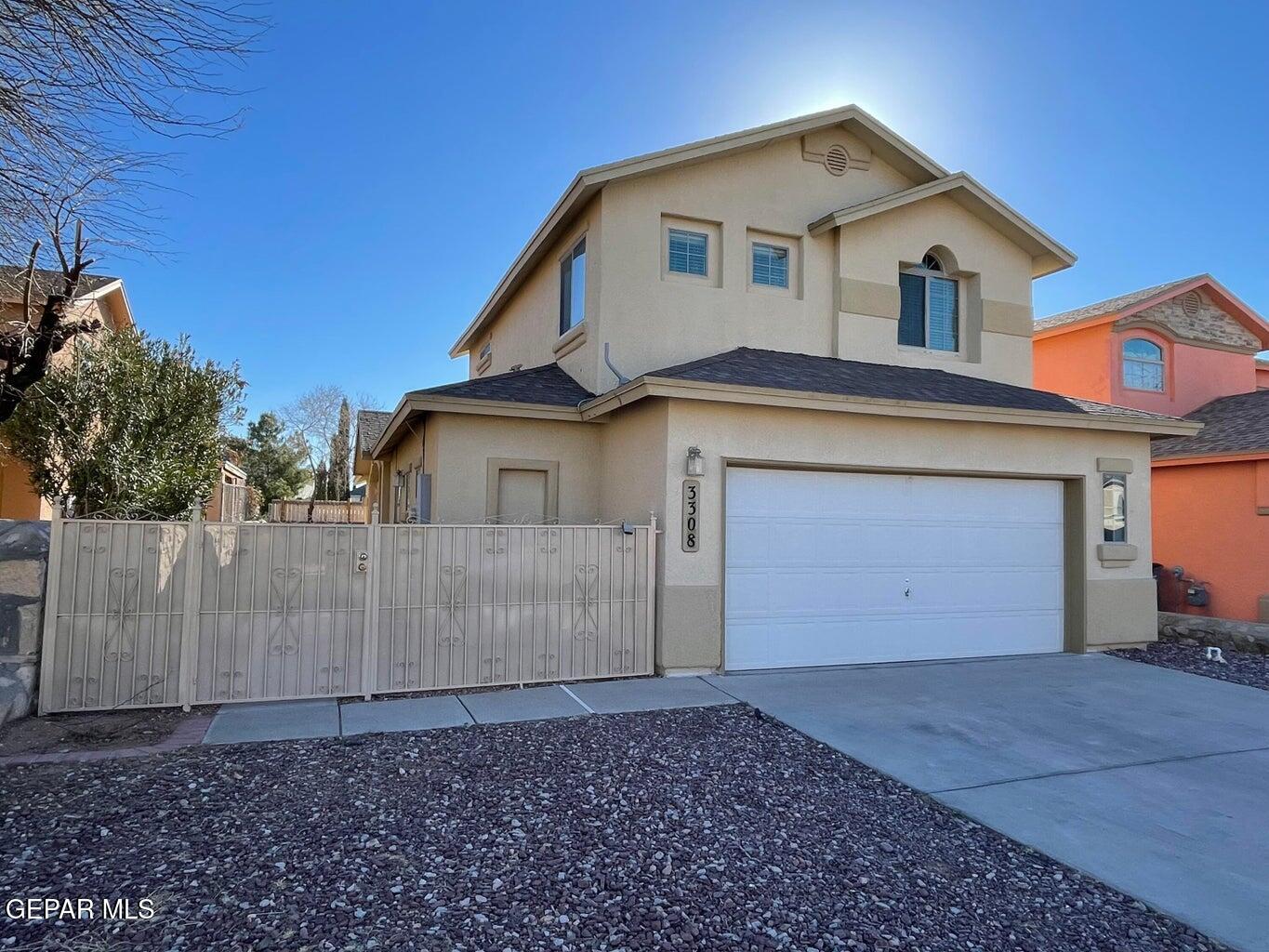 a view of a house with a yard and garage