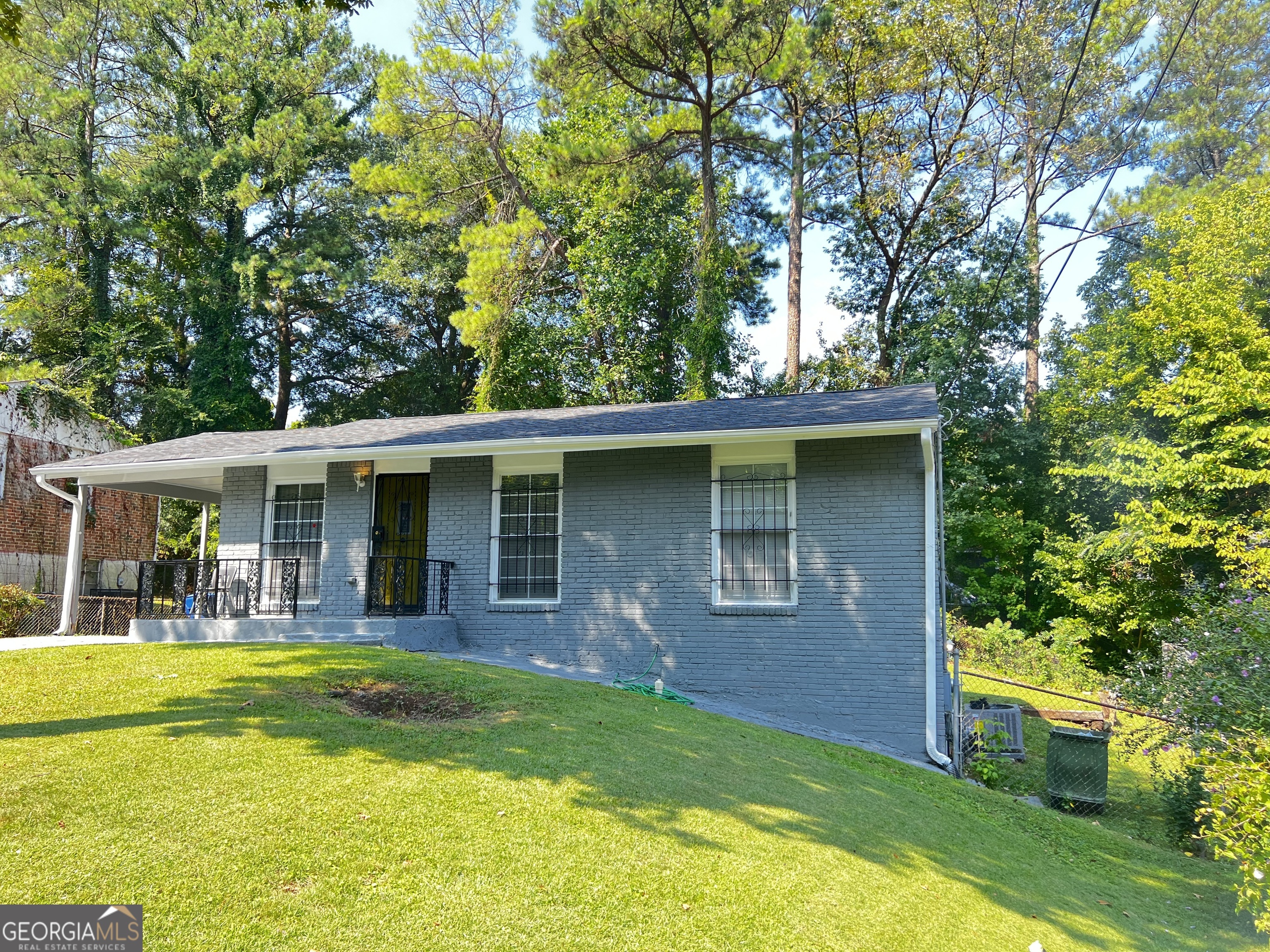 a view of a house with swimming pool and a porch with furniture