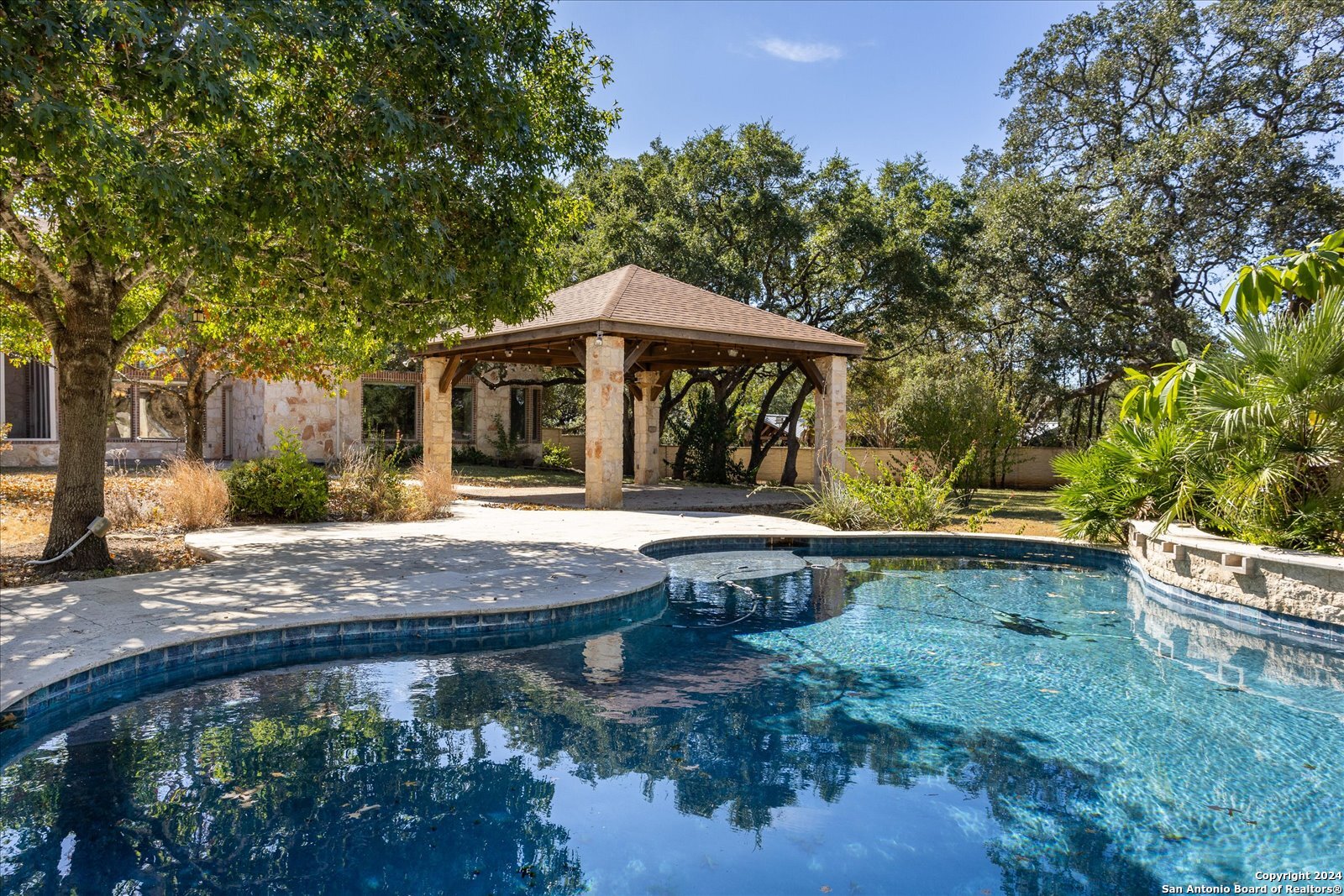 a backyard of a house with table and chairs