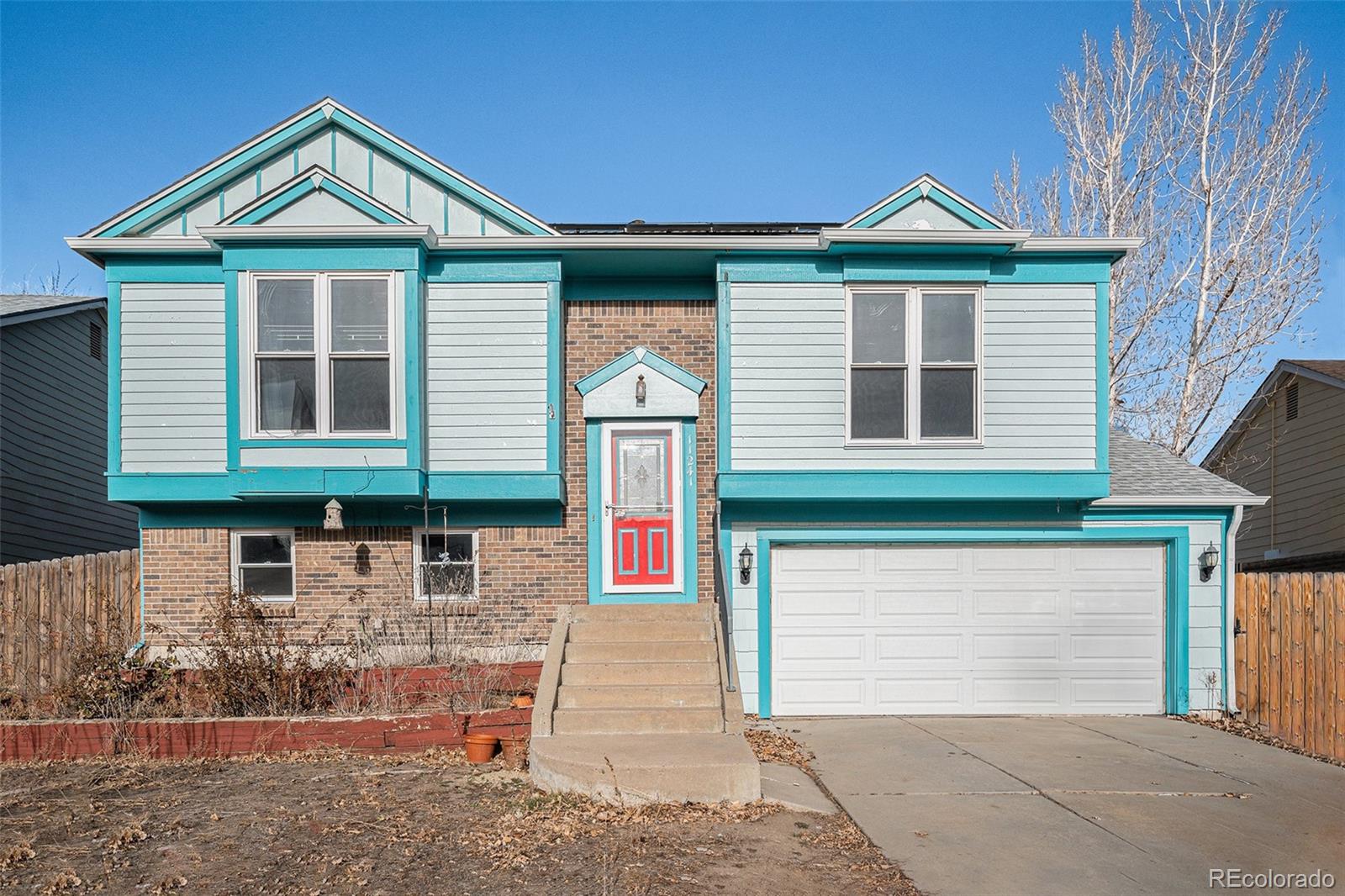 a front view of a house with garage