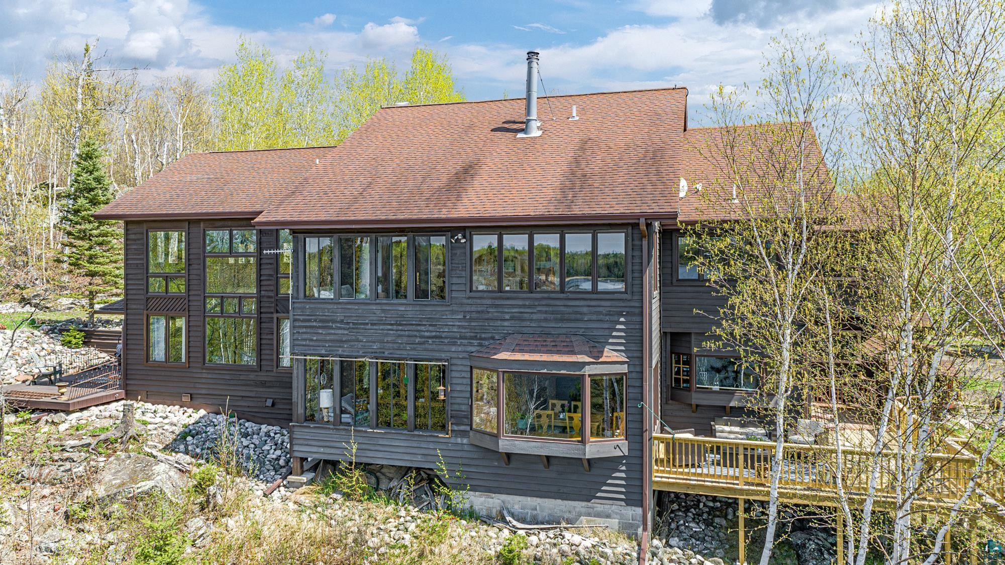 Lakeside view of house features a new deck