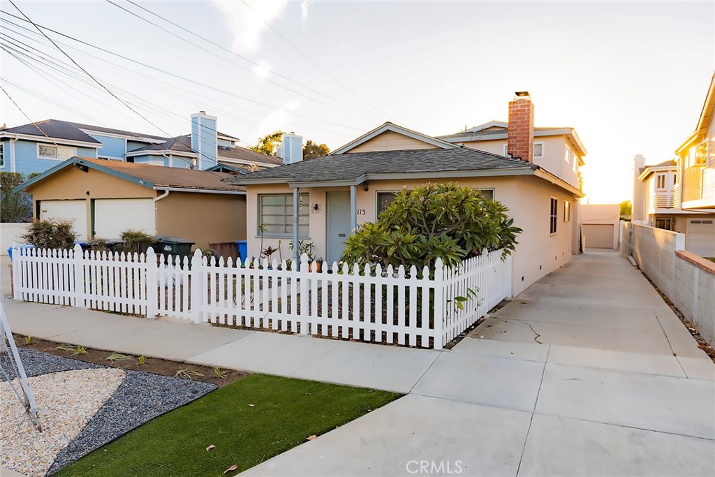 a view of a house with wooden fence