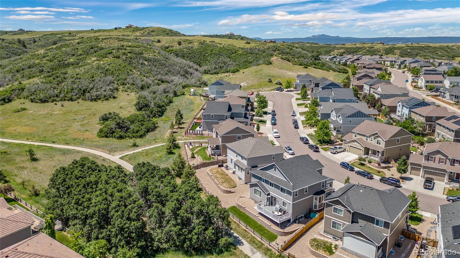 an aerial view of a residential houses with city view