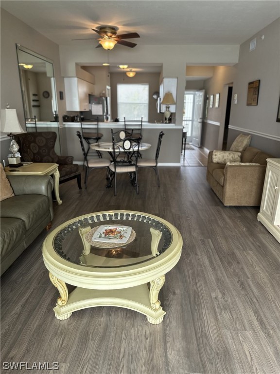 a living room with furniture a dining table and kitchen view