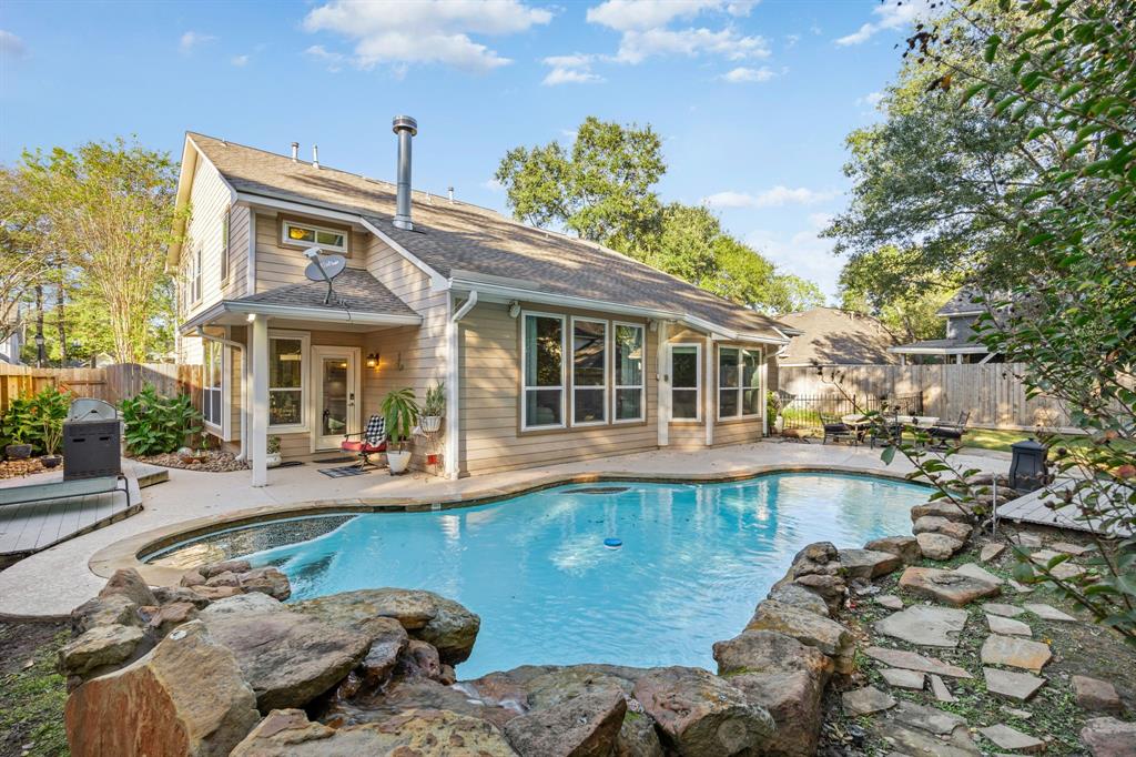 a view of a house with pool and sitting area