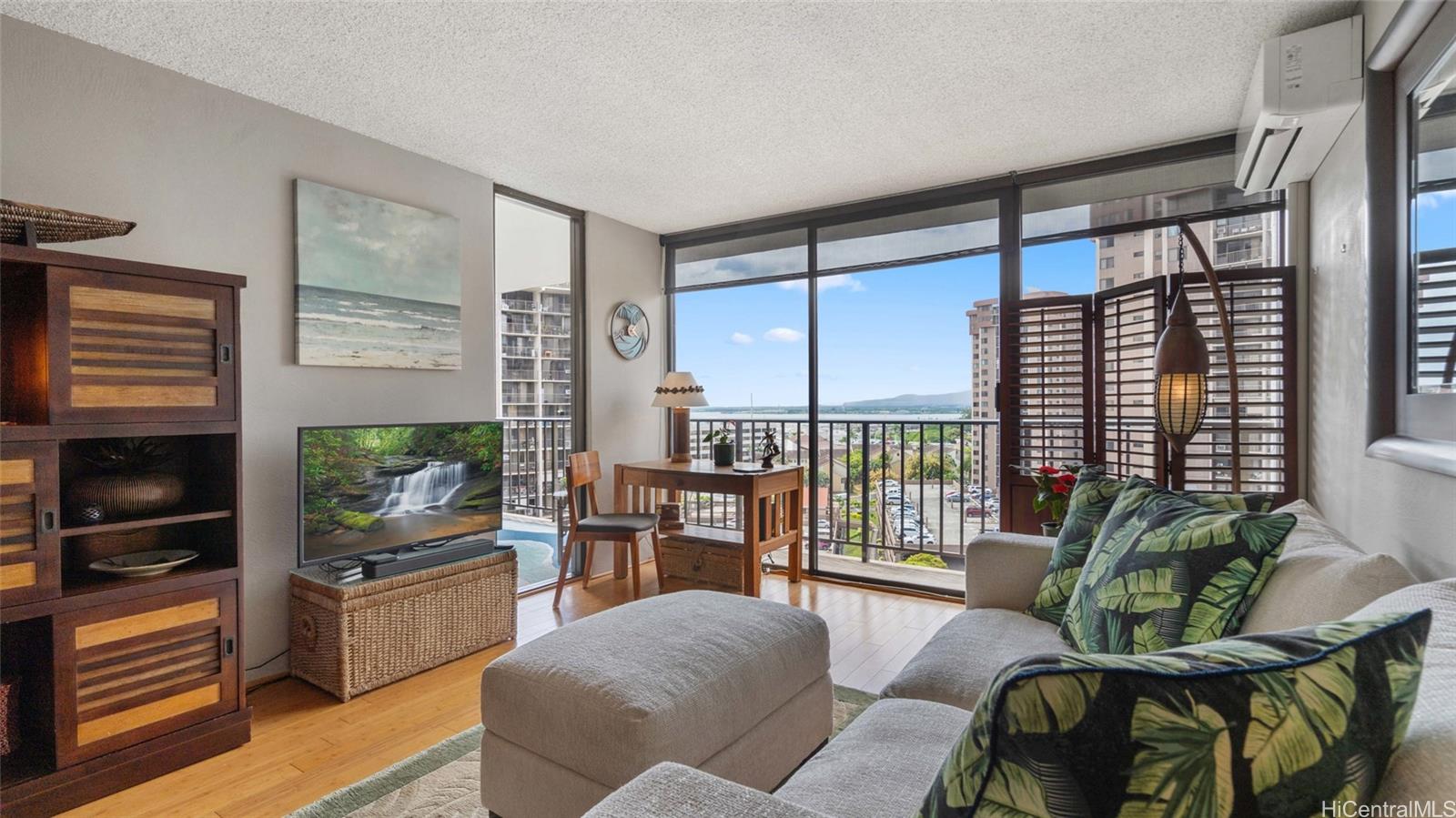 a living room with furniture a flat screen tv and a large window