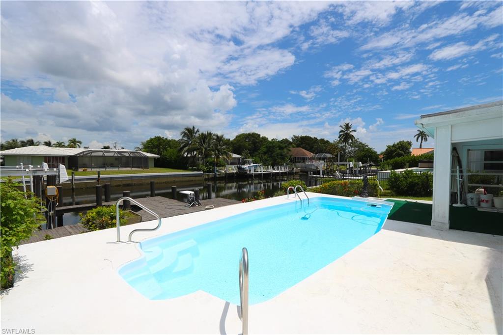 a view of a swimming pool with a lounge chairs