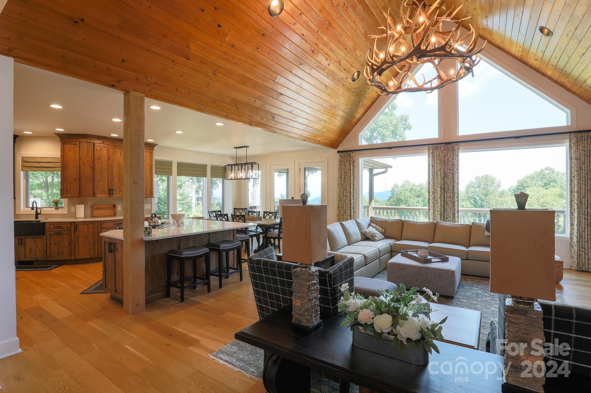 a living room with furniture a large window and a table