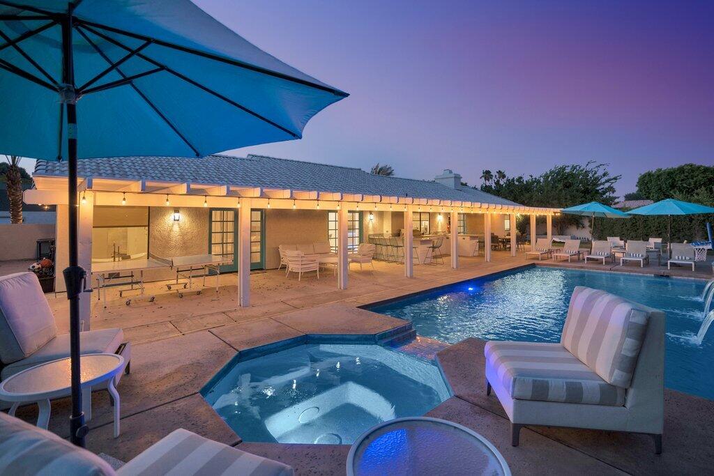 a view of swimming pool with seating space